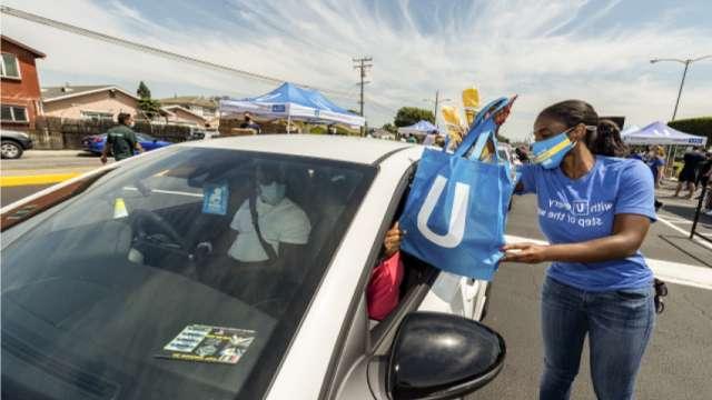 UCLA Health employee helping provide gift bags for patrons.