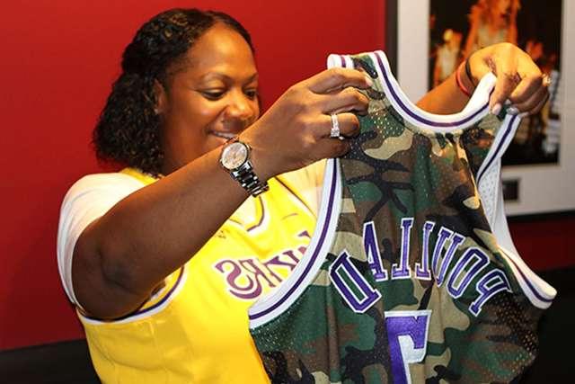 Yolanda Poullard looking at her custom made Lakers uniform.